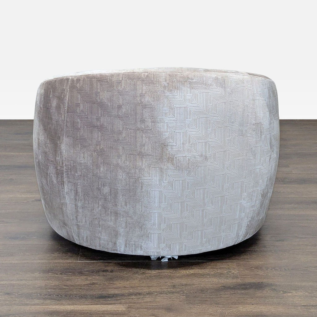 Round lounge chair by Mitchell Gold + Bob Williams with textured light grey upholstery, rear view shown.  