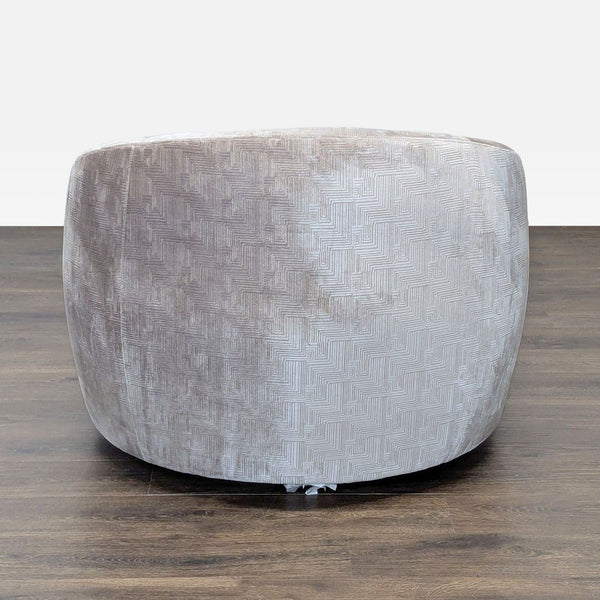 Round lounge chair by Mitchell Gold + Bob Williams with textured light grey upholstery, rear view shown.  