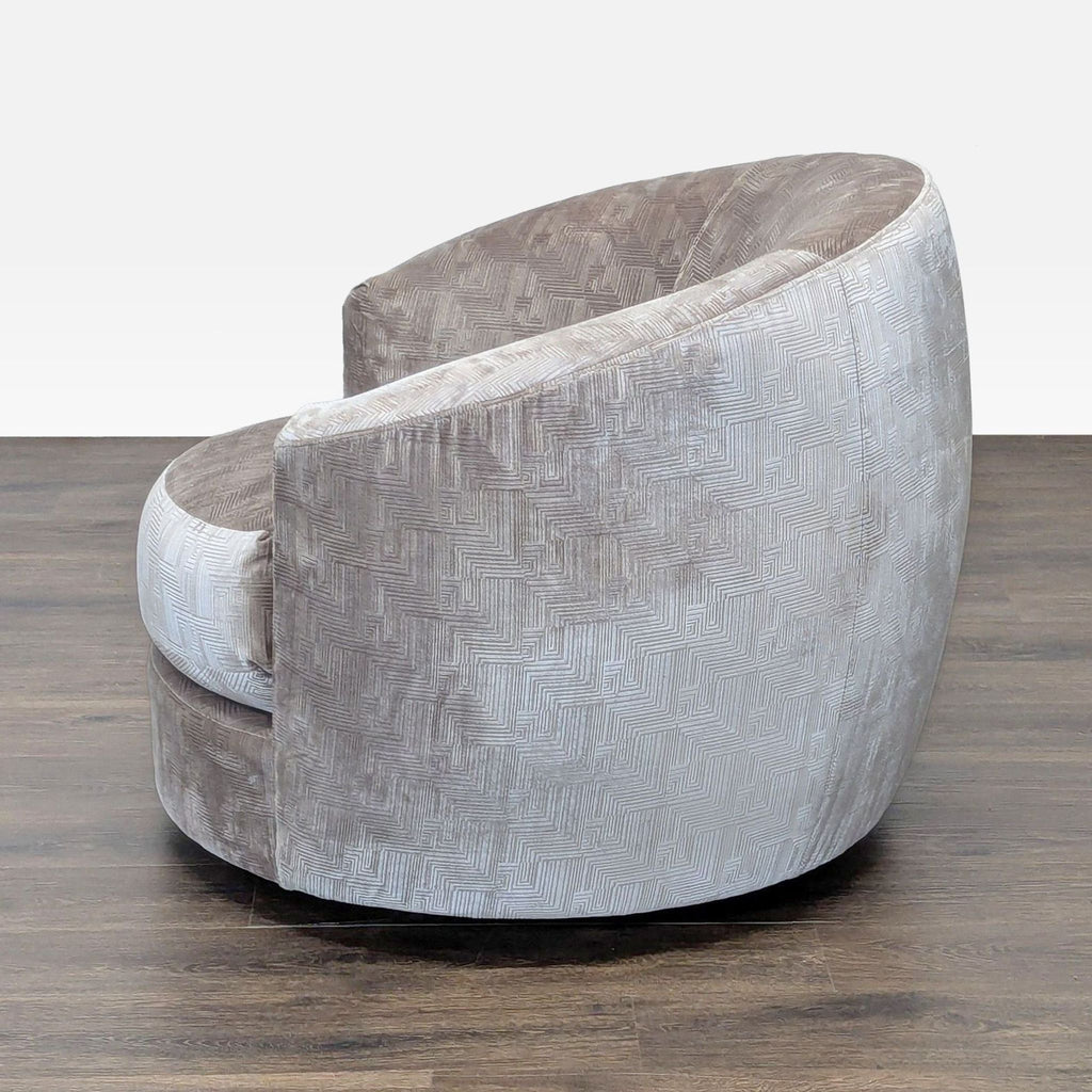 Mitchell Gold + Bob Williams swivel lounge chair, featuring curved back and patterned fabric, seen from the side.  