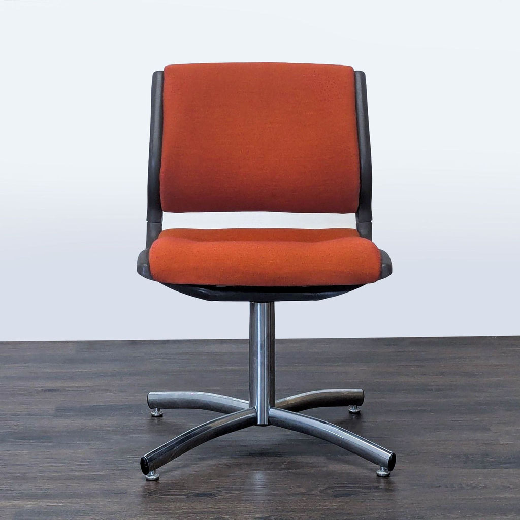 1. Front view of a Steelcase office chair with orange upholstery and a metal four-legged base.