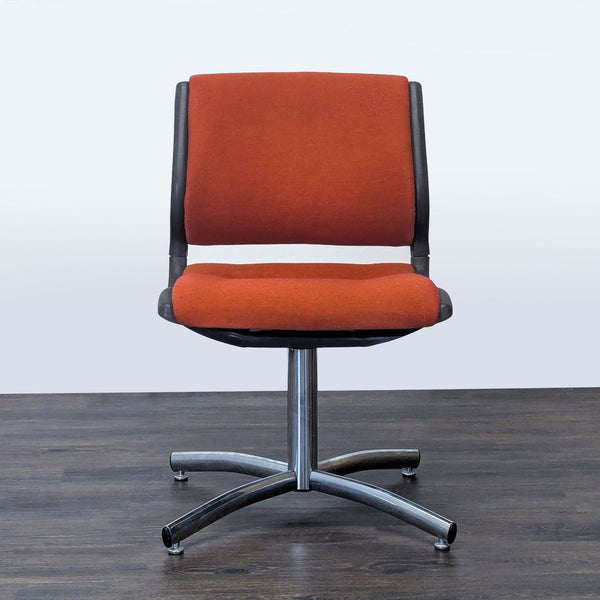 1. Front view of a Steelcase office chair with orange upholstery and a metal four-legged base.
