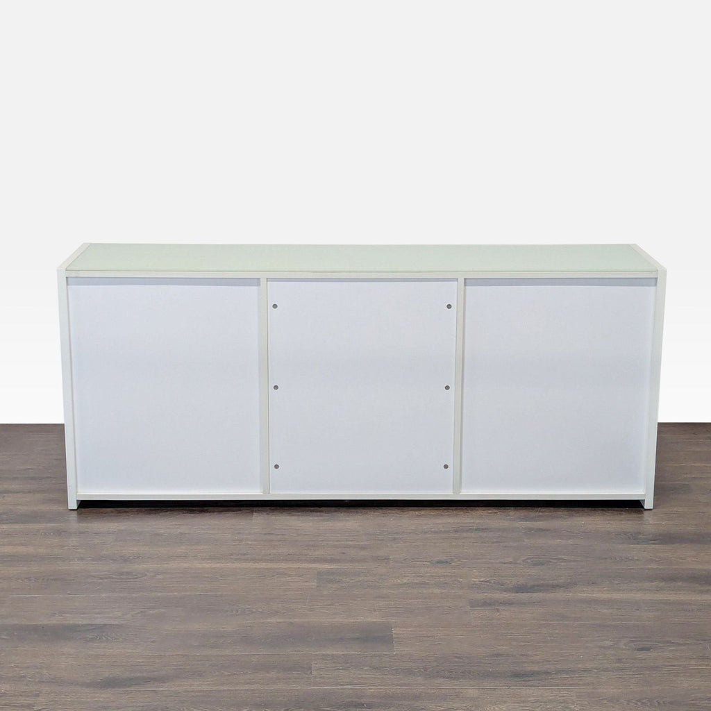 3. Front view of a sleek white Reperch dresser featuring three panel sections and a clean, contemporary style.