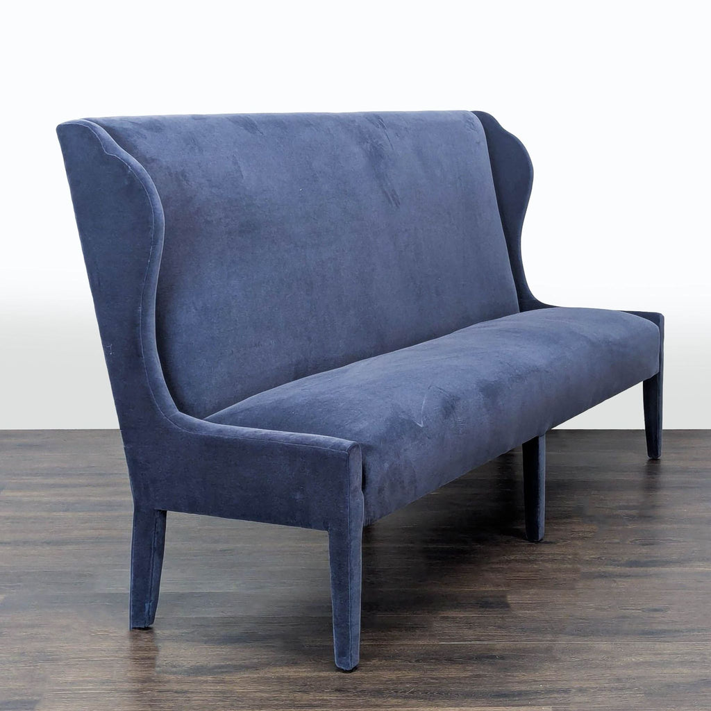 1. Side angle of the Verellen Amelie Banquette, showing its high curved backrest and elegant winged sides.