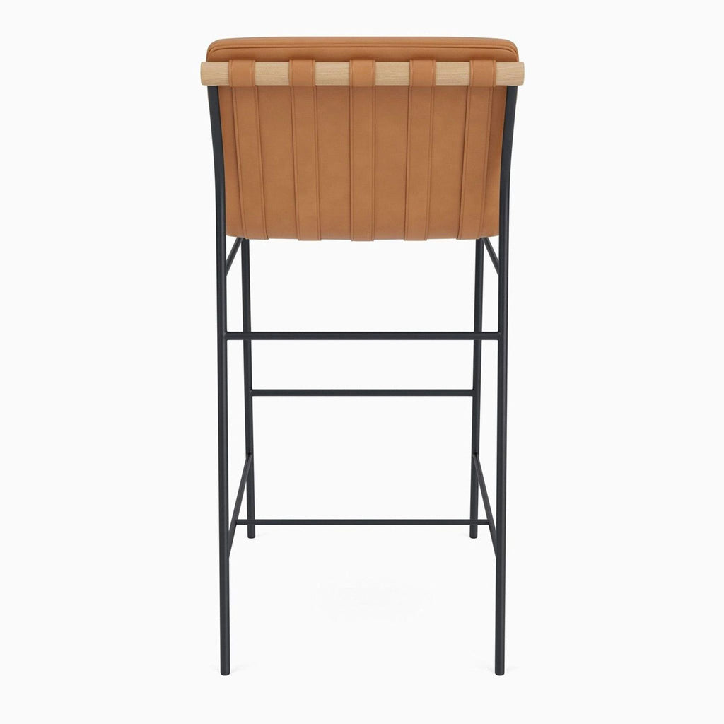 2. Minimalist storage rack featuring a white oak dowel and brown leather straps on a steel frame.  