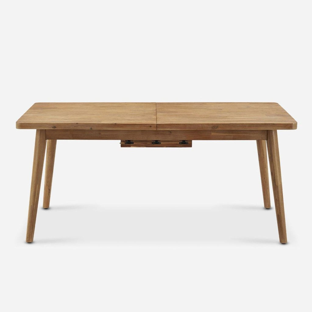 Castlery dining table in solid acacia wood with muted honey tone, expandable with a butterfly leaf mechanism.