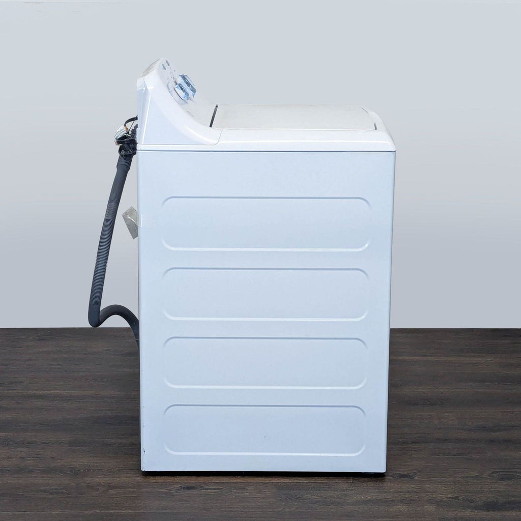 Reliable GE top load washing machine in white, offering simple operation and dependable cleaning performance.