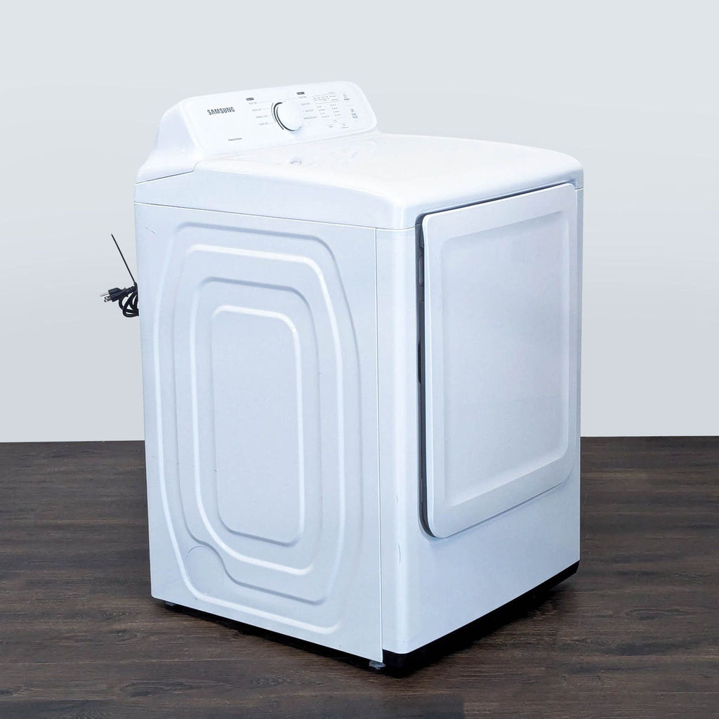 3. Angled side view of a Samsung washer/dryer, displaying the sturdy build and power cord on a wood floor.