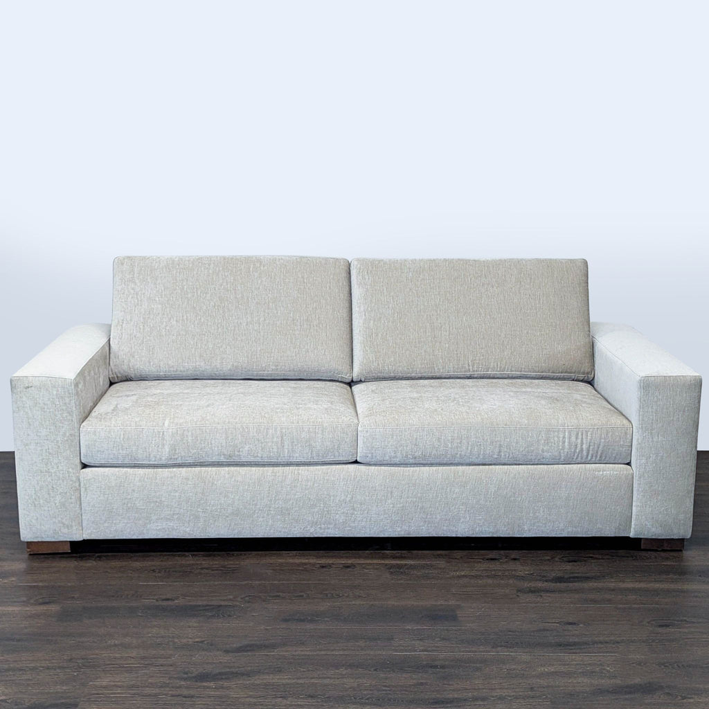 1. Front view of a Reperch brand 3-seat sofa, upholstered in light gray fabric with block arms.