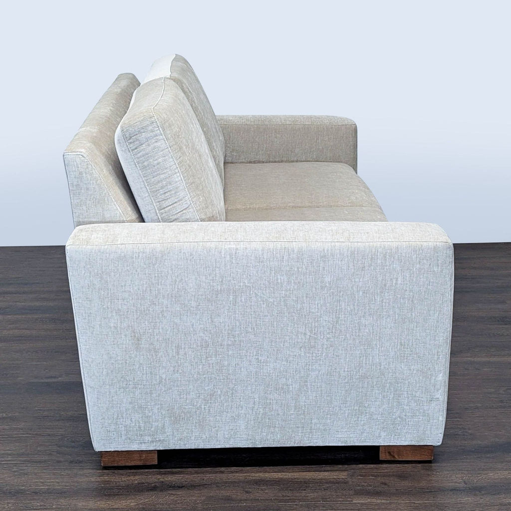 3. Side profile of a Reperch 3-seat sofa, showing its straight armrest and thick seat cushions.