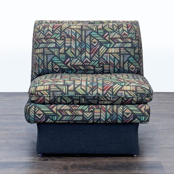 1. Front view of a Reperch lounge chair with multicolored geometric patterned upholstery and black base.