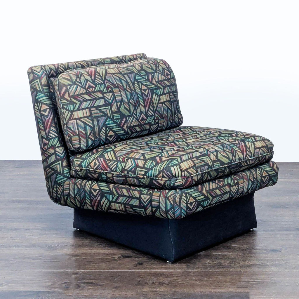 2. Angled side view of a Reperch lounge chair, featuring a colorful geometric fabric design and cushioned seat.