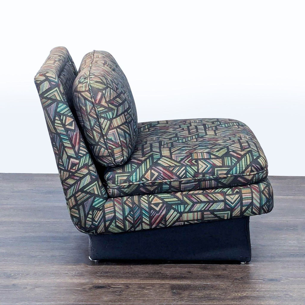 3. Profile view of a Reperch lounge chair, showing its bold geometric upholstery and plush seating on a dark base.