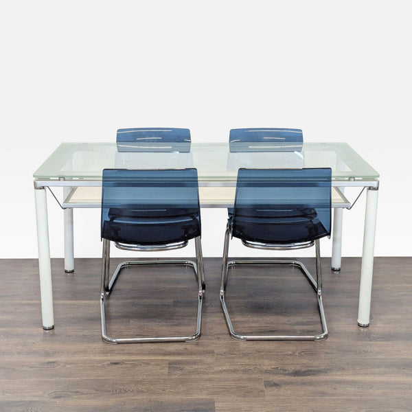 Modern dining set with glass-top table, white metal legs, and four blue chrome-base chairs.