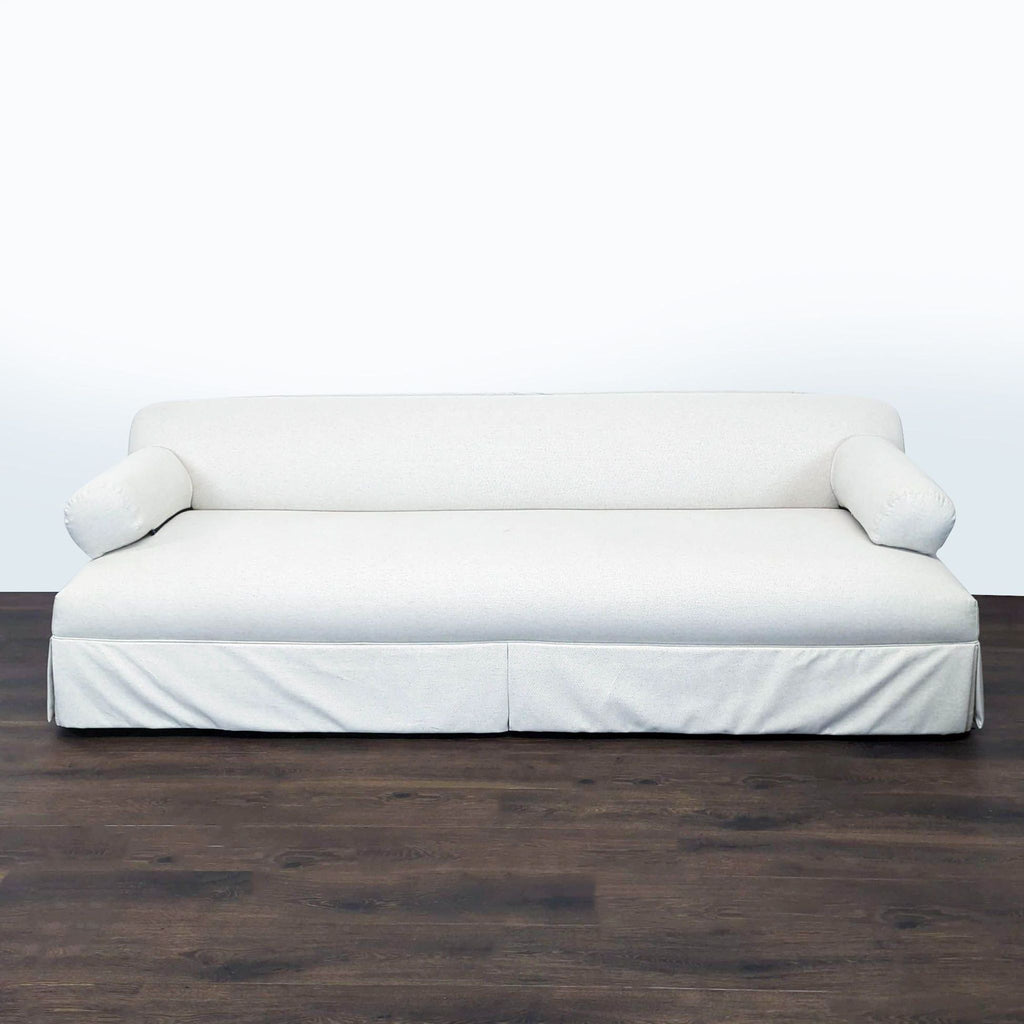 Three-seat sofa by Shoppe Amber Interiors with modern, clean lines and light beige Aspen upholstery.