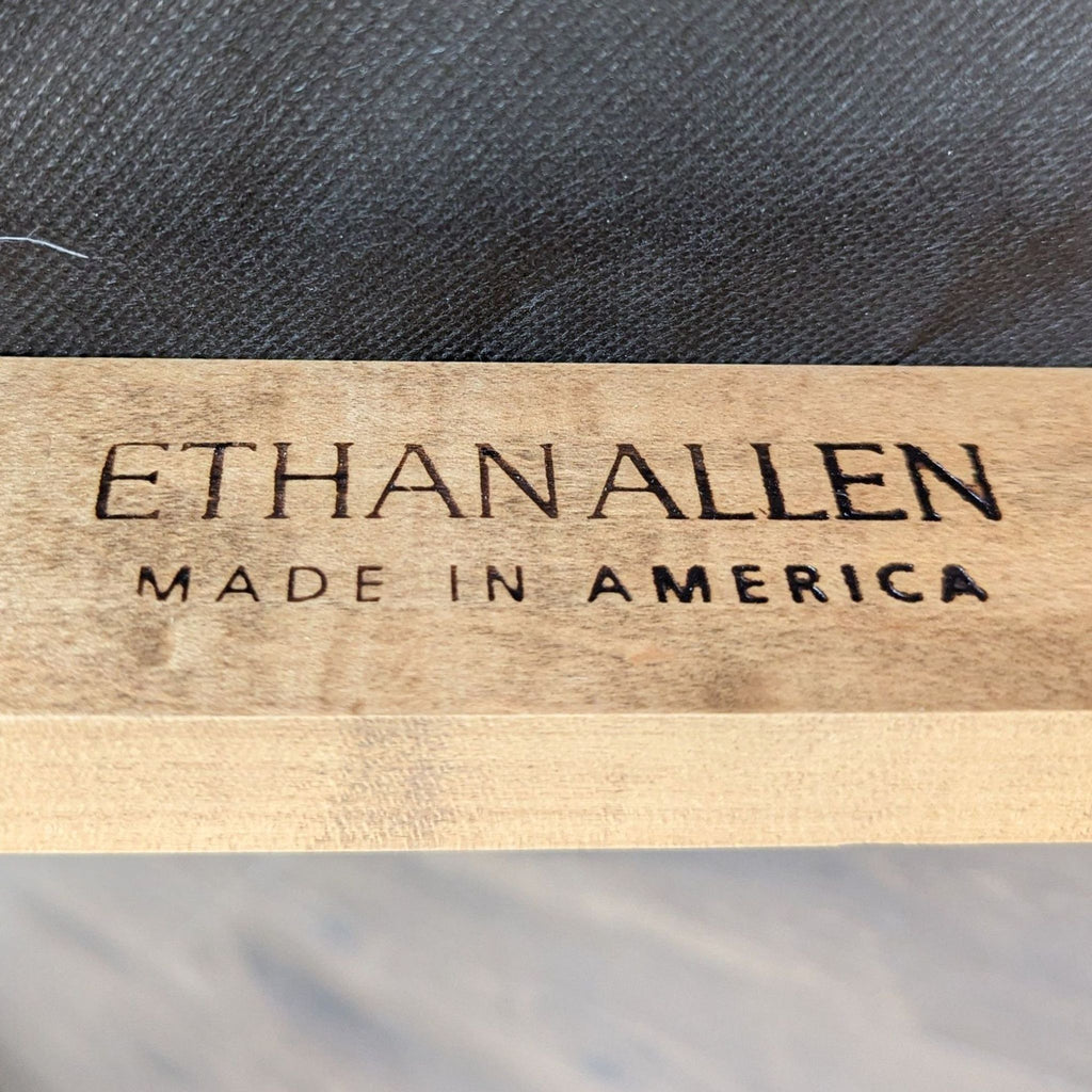 Expandable Ethan Allen dining set featuring black seat chairs and a warm wood table, for dining rooms.