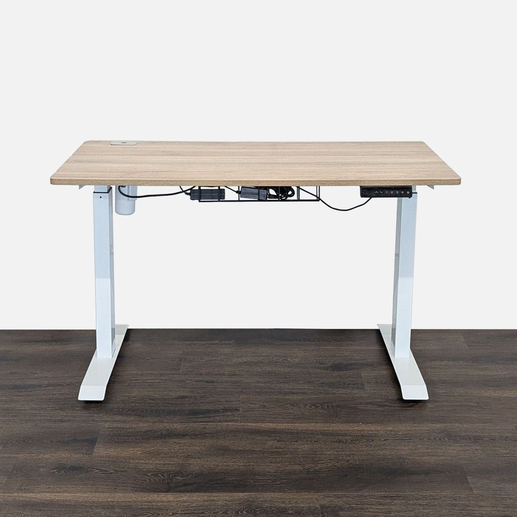 Modern height-adjustable desk with light wood surface, white metal legs, and built-in cable management tray.