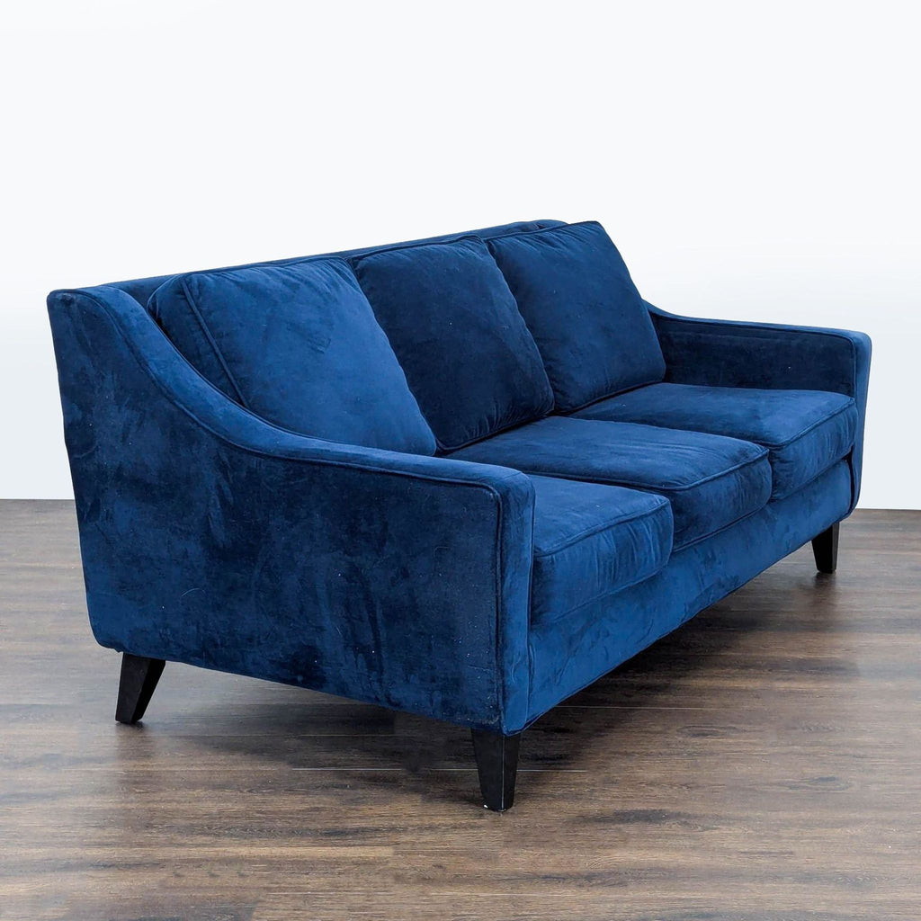 Modern blue velvet 3-seater by Fusion Furniture, featuring sturdy legs and comfortable seating for any space.