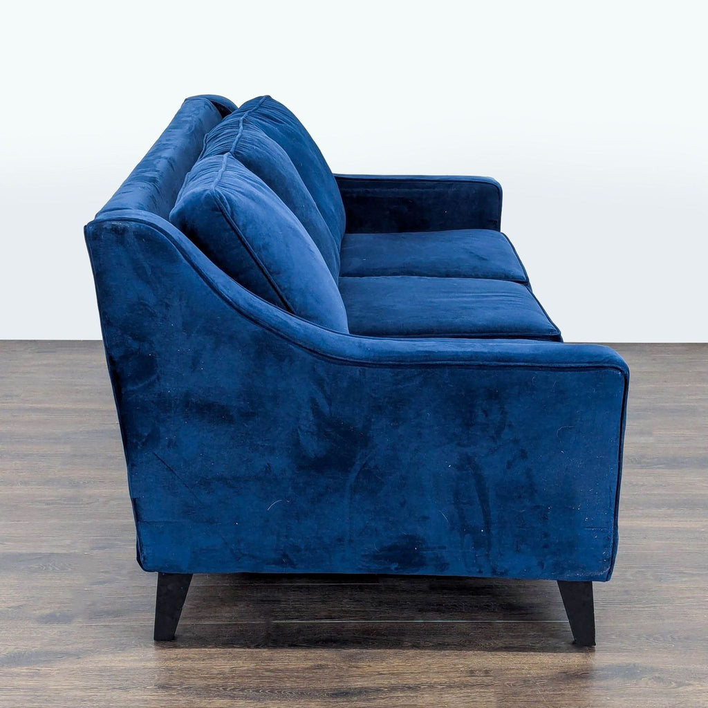 Blue velvet Fusion Furniture 3-seat sofa with plush cushions and wide seating, suitable for families and guests.  