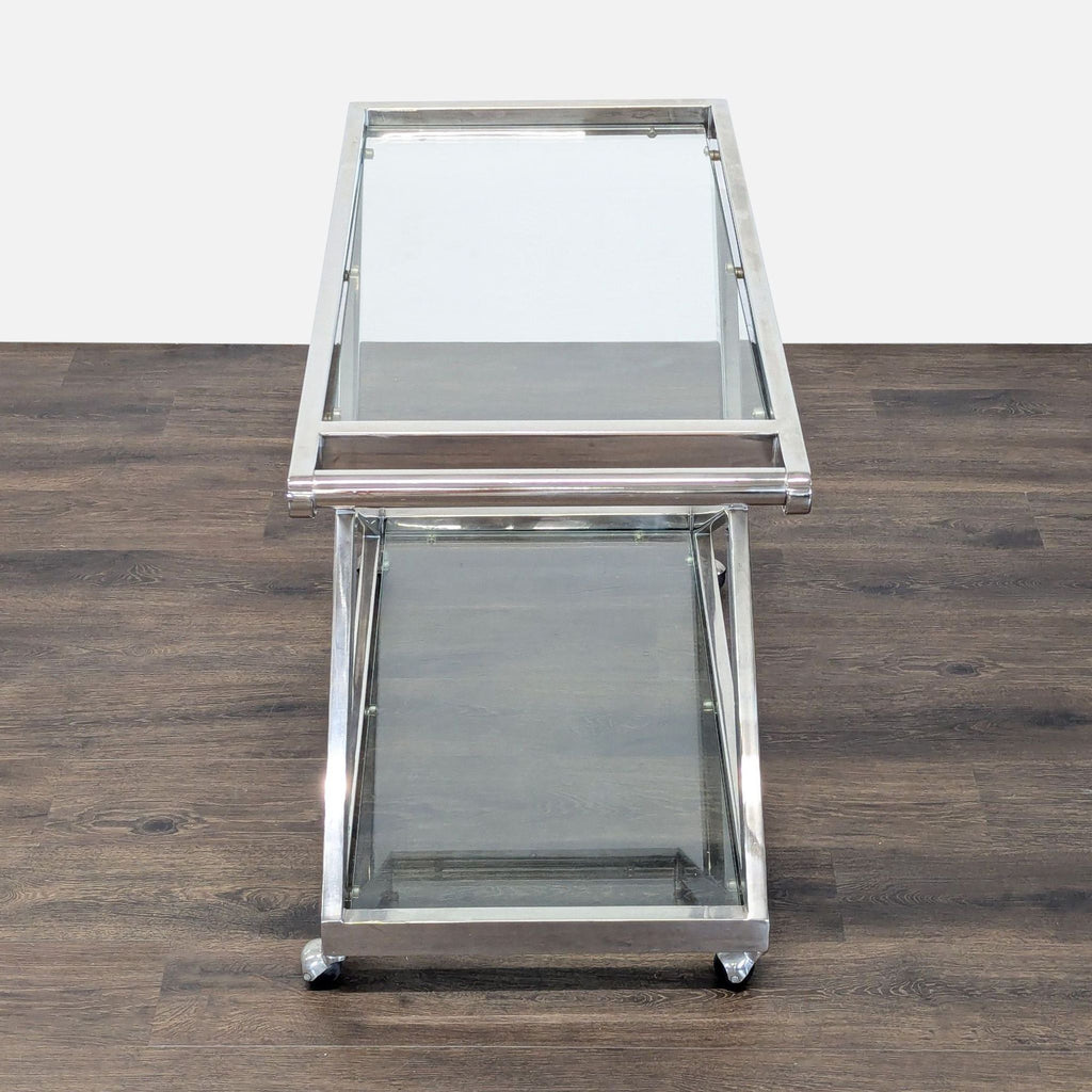 Restoration Hardware bar cart featuring an X-frame in gleaming nickel, glass shelves, and smooth-rolling wheels.