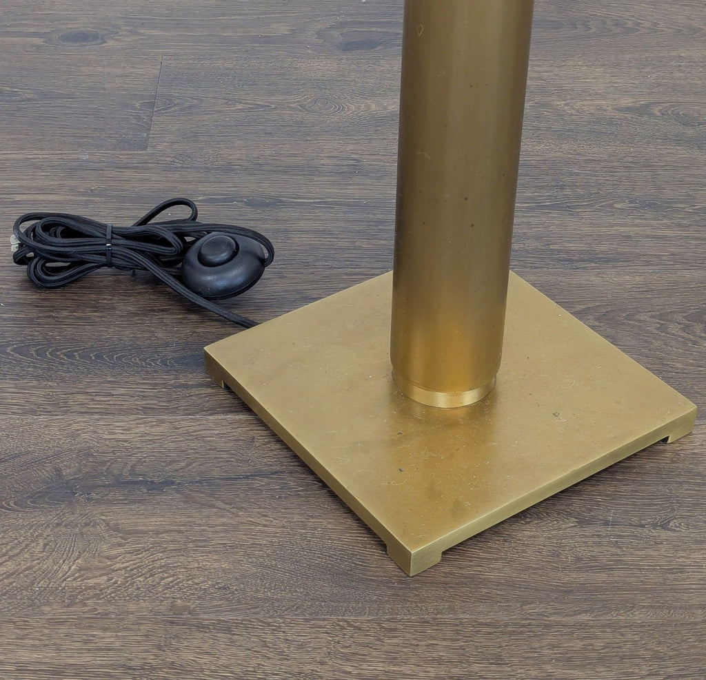 Contemporary brass and black floor lamp, perfect for adding bright, warm light to any room decor.