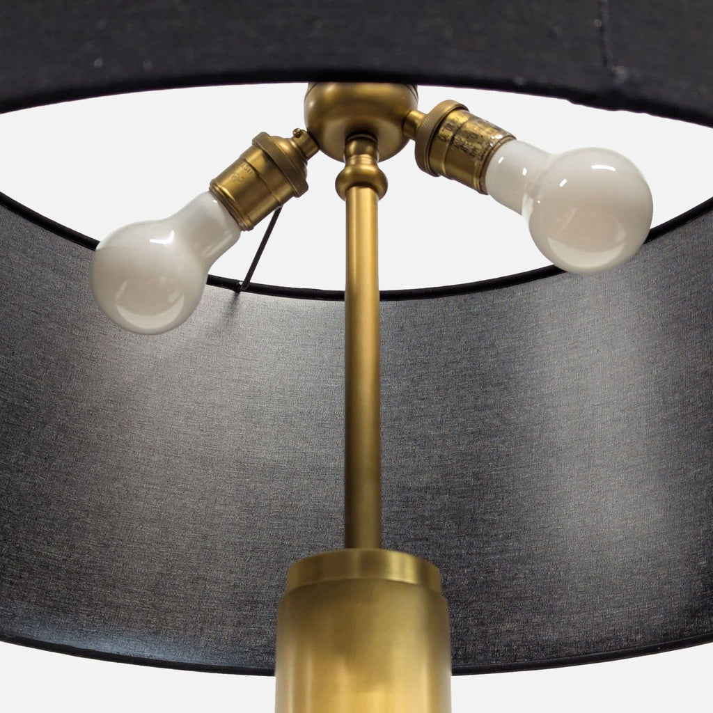 Elegant floor lamp featuring a black shade, brass base, and foot switch for convenient, practical lighting.