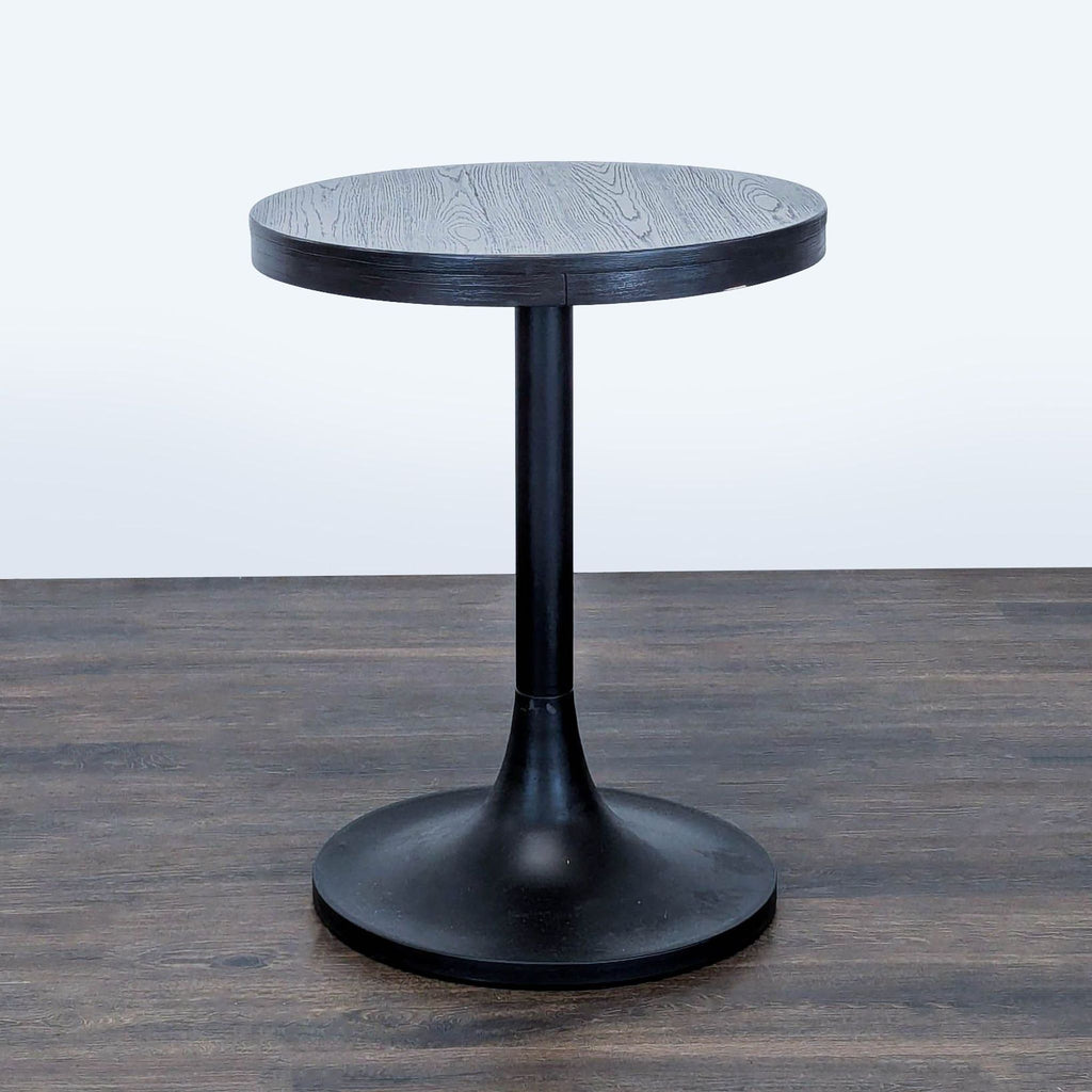1. Round wood tabletop table with a sleek metal tulip base by Williams Sonoma.  
