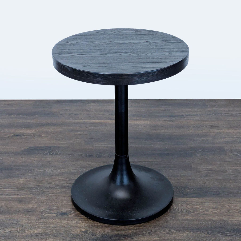 Williams Sonoma side table featuring a wooden top and minimalist metal tulip pedestal base.  