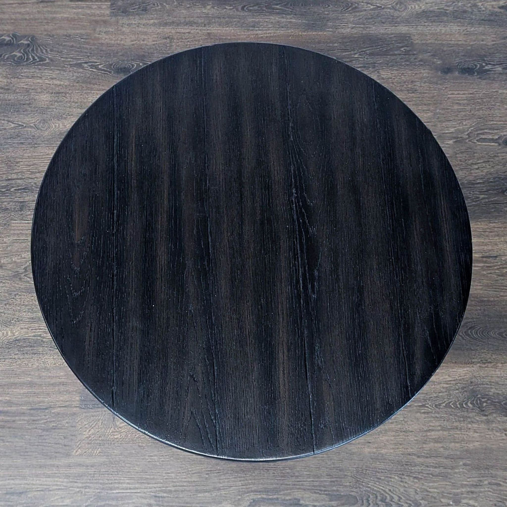 Modern console table from Williams Sonoma with a metal tulip base supporting a wood tabletop.