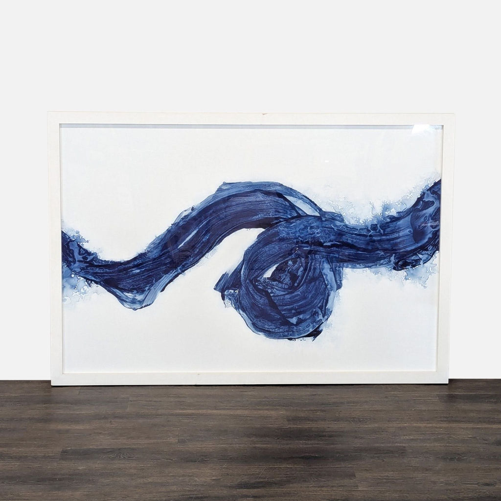 Abstract painting by Maker & Moss with bold blue brushstrokes on white, framed for easy hanging.