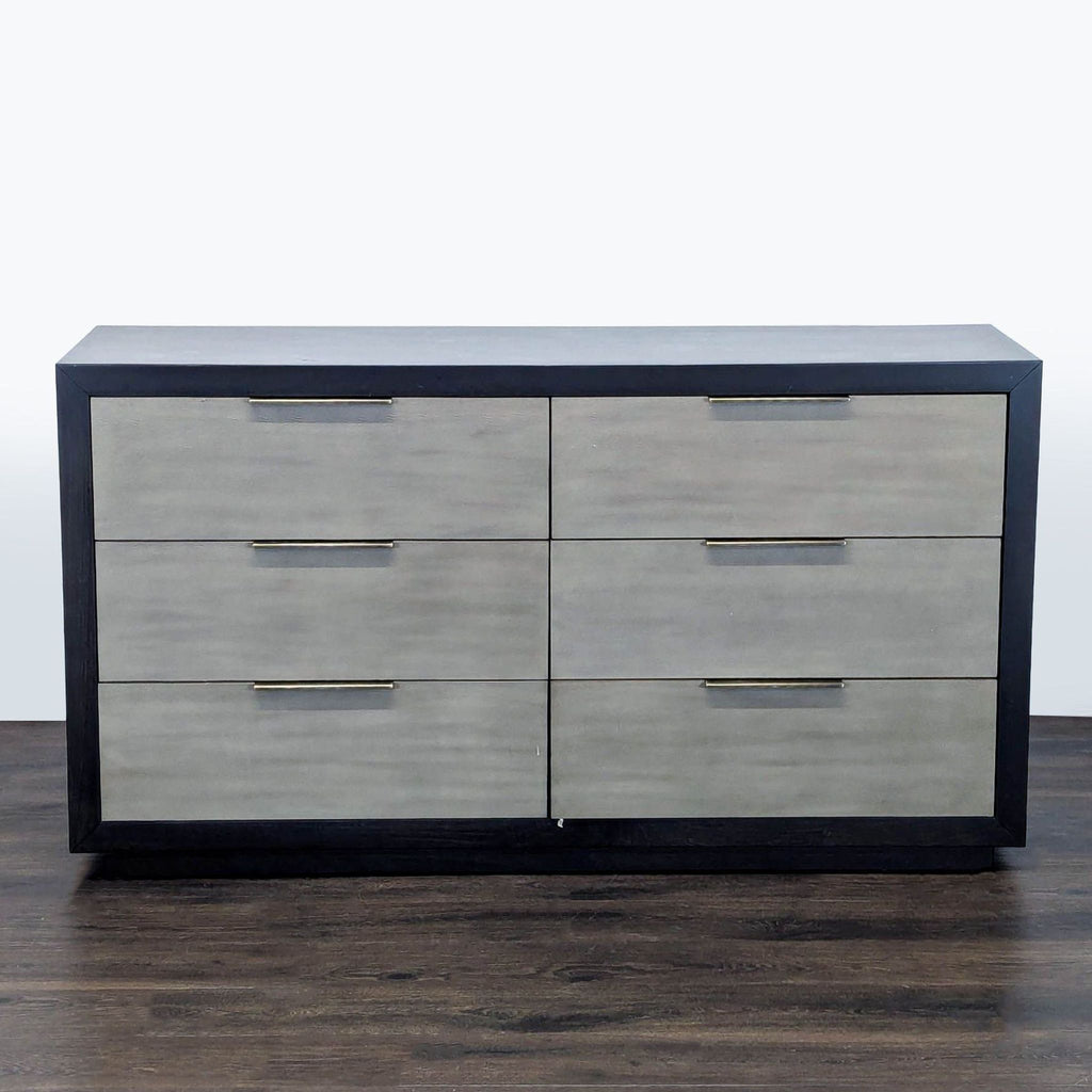 Modern six-drawer Living Spaces dresser with black frame, gray fronts, and metal handles for added style.