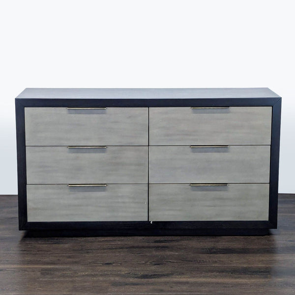 Modern six-drawer Living Spaces dresser with black frame, gray fronts, and metal handles for added style.