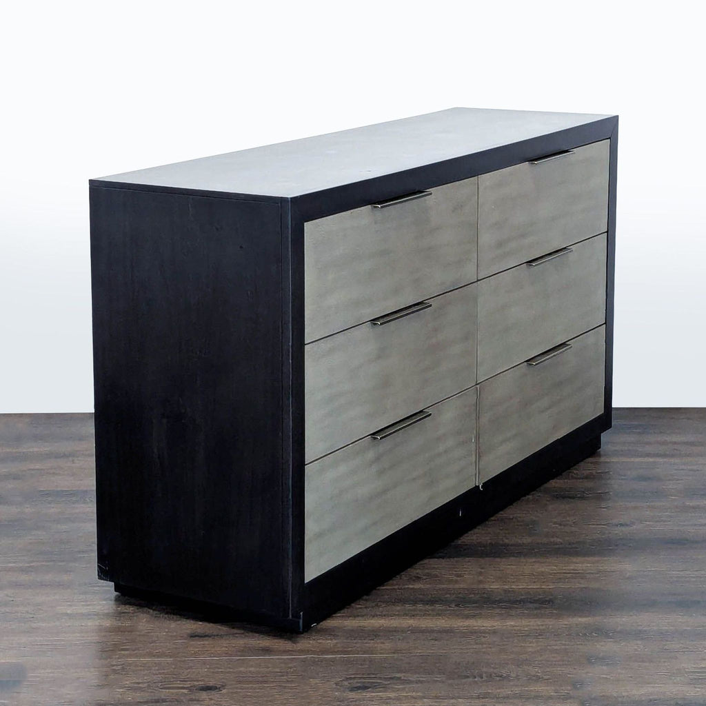 Contemporary Living Spaces dresser in black and gray with six drawers and minimalist metal handles.