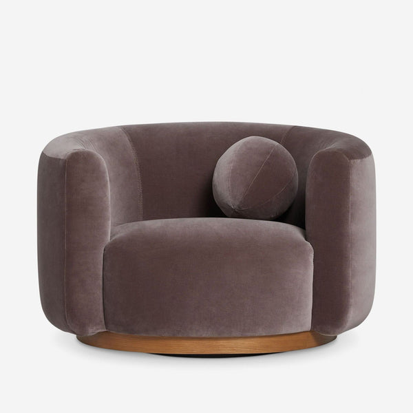 Lulu and Georgia taupe velvet lounge chair with round pillow, deep seat, and swivel wooden base.