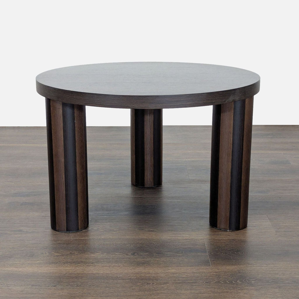 Brutalist-inspired coffee table by Ferm Living with elegant striped marquetry inlay on the surface.