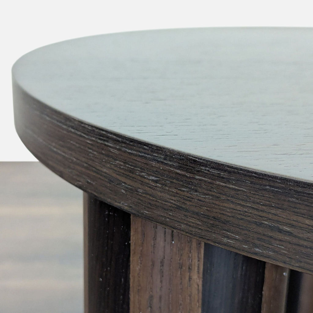 Ferm Living coffee table showcases brutalist influence with unique marquetry stripes on its refined tabletop.