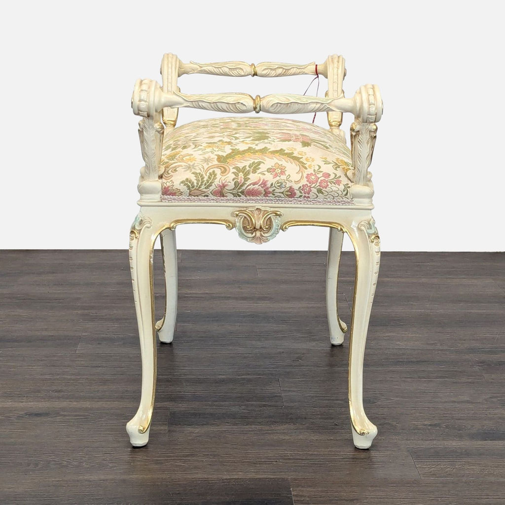 Decorative bench featuring scrolled armrests, painted woodwork, and curving cabriole legs.