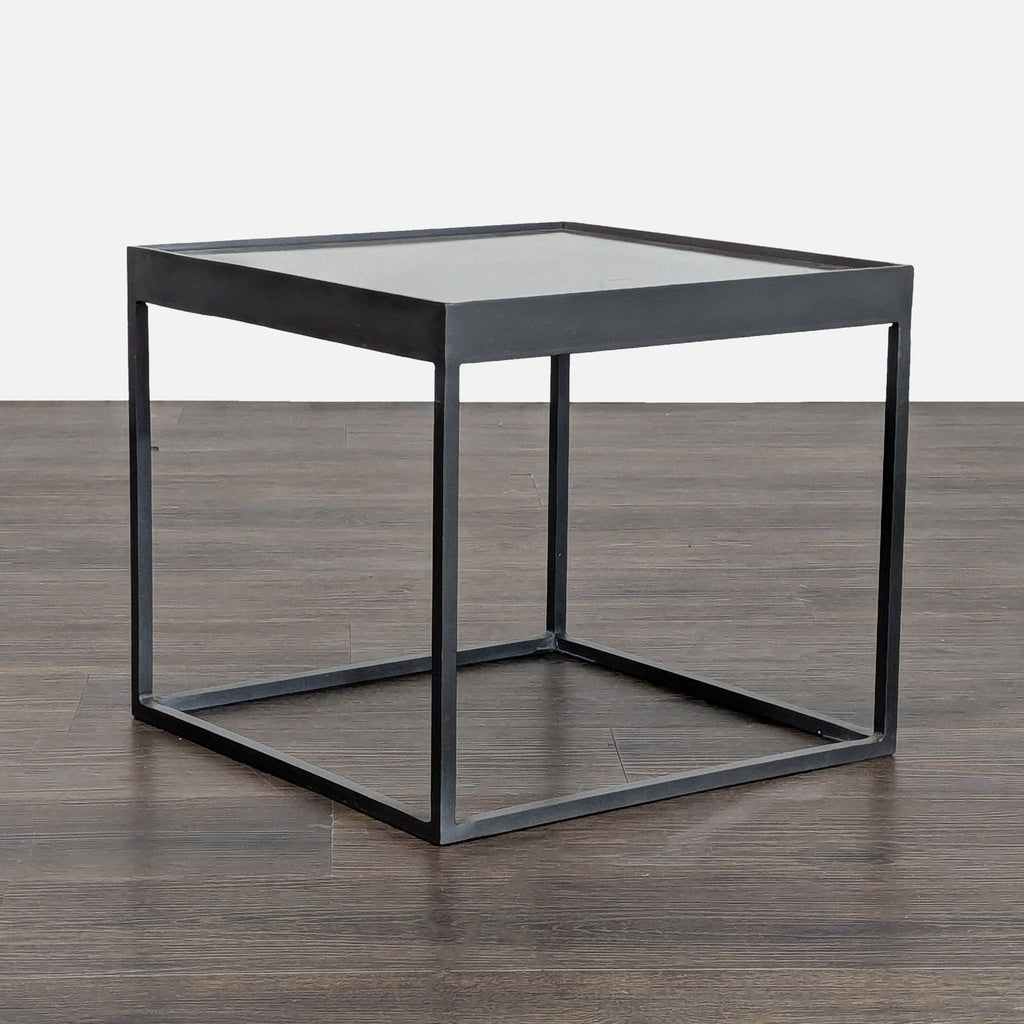 2. Black metal square side table with open frame base, displayed at an angled perspective on wood flooring.  