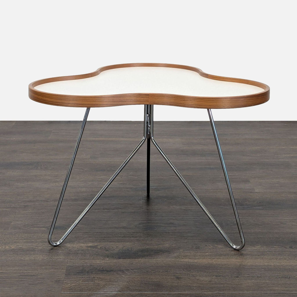 Organic-shaped Swedese end table by Christine Schwarzer with a laminate wood top and chrome stem base.