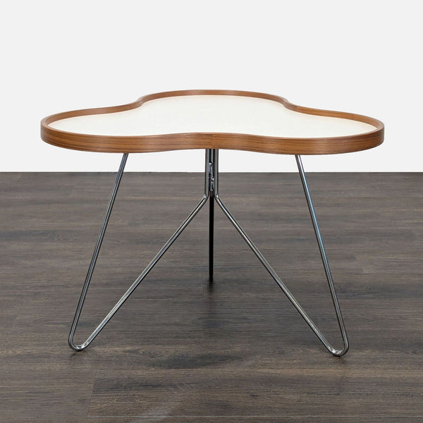 Organic-shaped Swedese end table by Christine Schwarzer with a laminate wood top and chrome stem base.