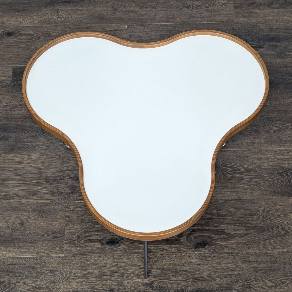 Contemporary end table by Christine Schwarzer for Swedese, with a wavy laminate top and sleek chrome base.