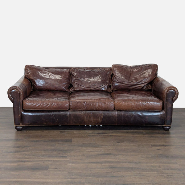 Restoration Hardware brown leather 3-seat sofa with rolled arms, vintage look, and visible characterful wear.