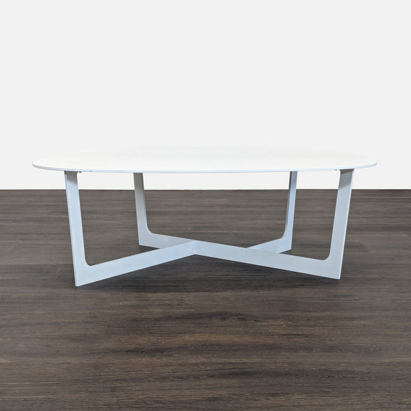 Minimalist aluminum coffee table by Jorgensen, designed by Ernst & Jensen, features sleek curves and plastic glides.  