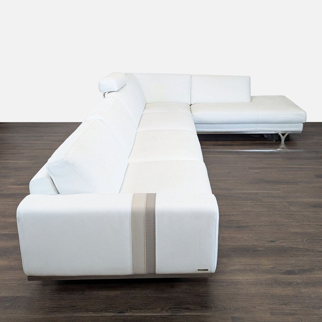 2. Modern Roche Bobois white leather sectional viewed from side, showing chaise and adjustable headrest.