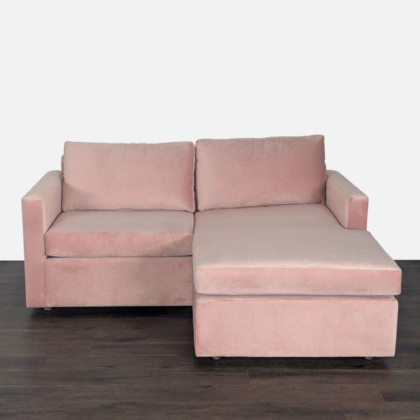 Modern pink velvet sectional sofa with reversible chaise and sturdy arms, designed for comfort and style.  