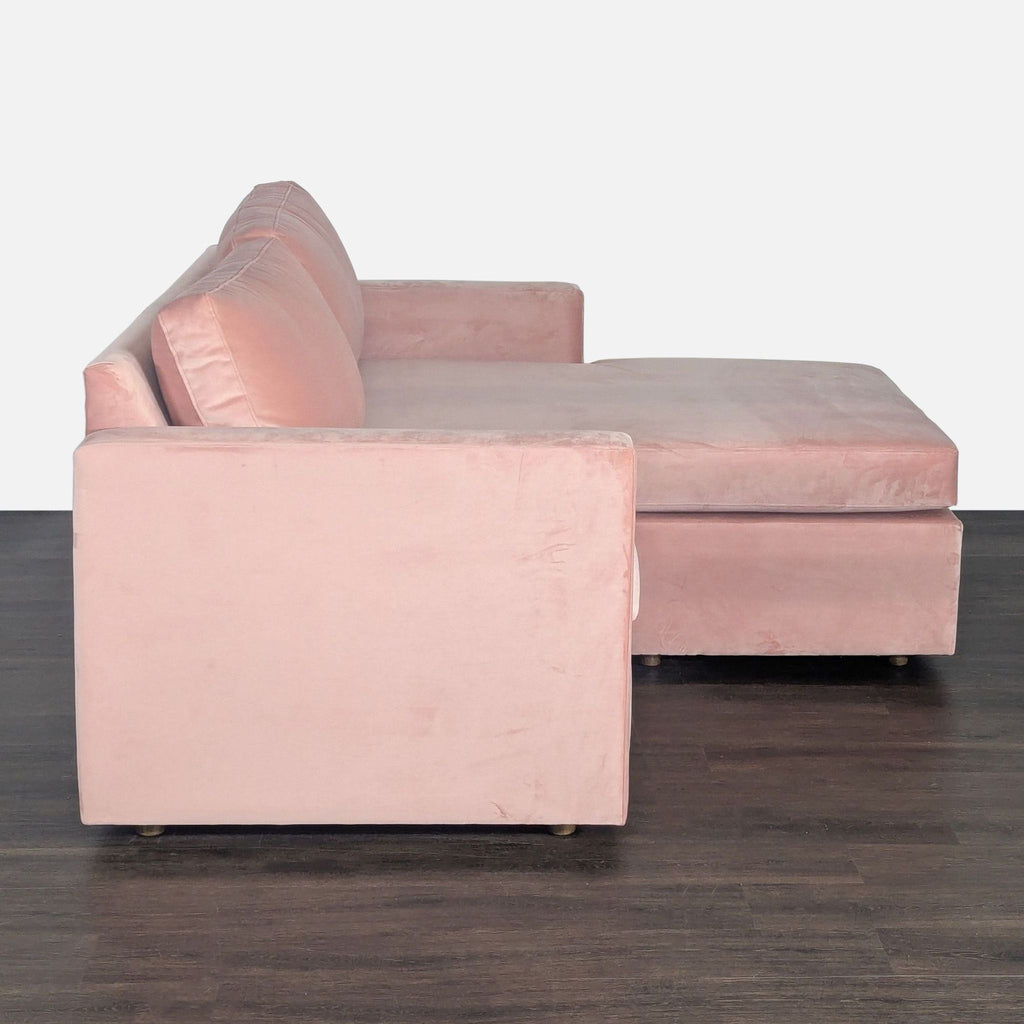 Custom pink velvet sectional featuring plush cushions and a spacious lounge, ideal for trendy living rooms.  
