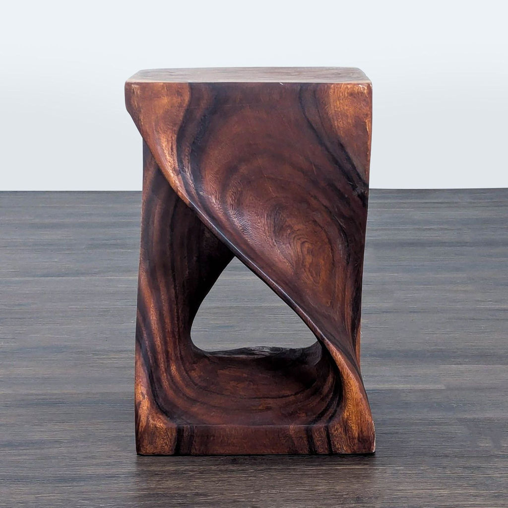 1. Sculptural wooden side table with a twisted open design, crafted from dark, richly grained wood.