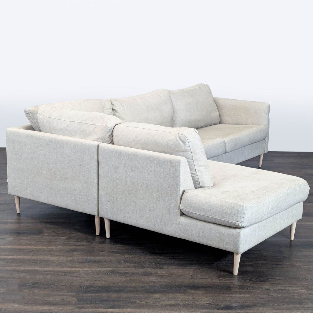 Spacious cream sectional by BoConcept, featuring a chaise for relaxation and minimalist design, perfect for living rooms.