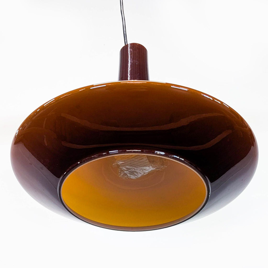 1. Brown glass pendant lamp with a wide, rounded shade and orange interior, suspended from a black cord.