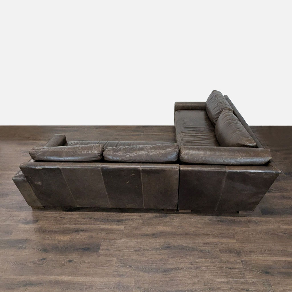 3. Back angle of a Restoration Hardware sectional, brown leather upholstery, comfortable seating, gently worn.