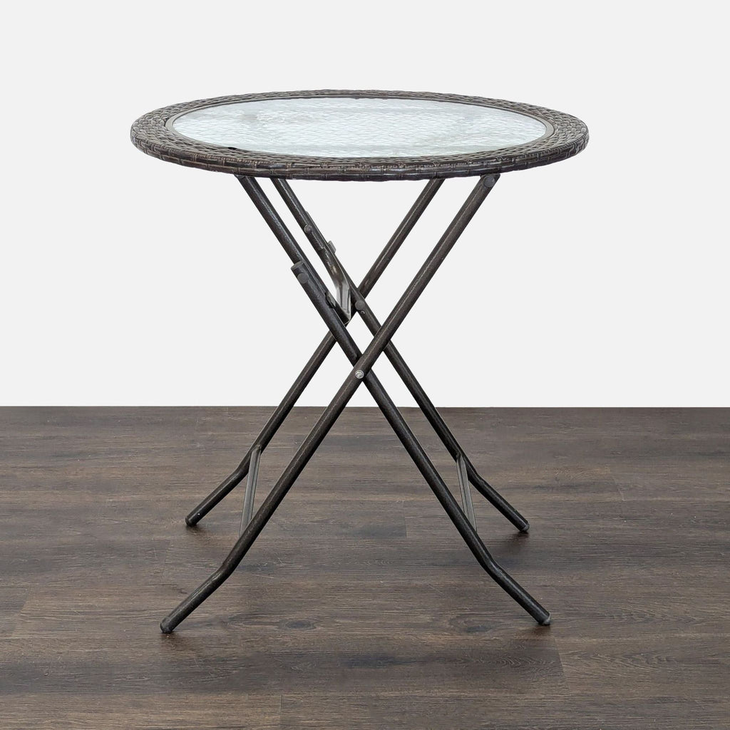 Lightweight patio set with glass table and four foldable rattan-look chairs, suitable for indoor or outdoor use.